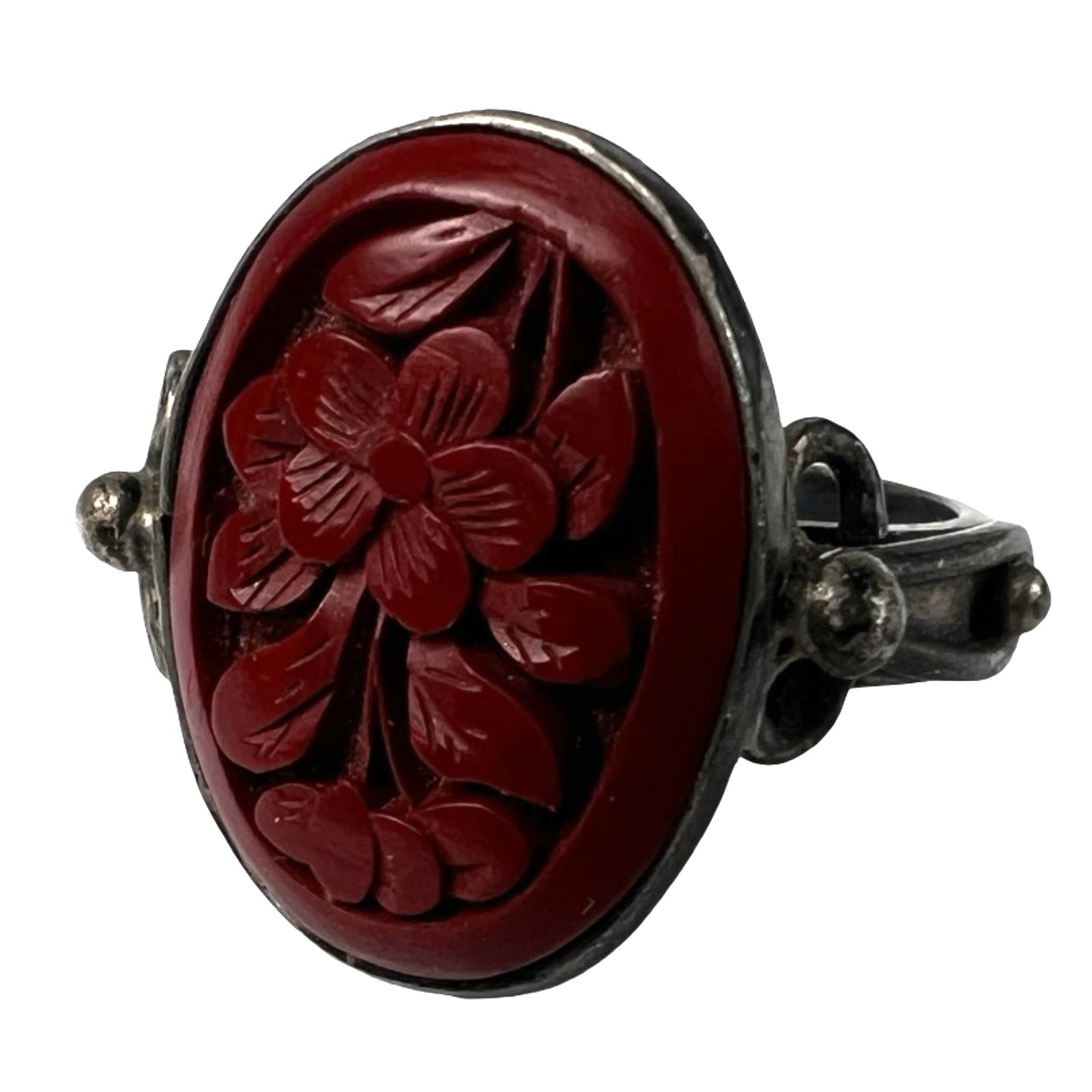 Sterling Silver Carved Red Cinnabar Floral Ring: Elegant vintage sterling silver ring featuring a detailed hand-carved red cinnabar centerpiece with an intricate floral motif. The oval cinnabar carving is set in a bezel with decorative silverwork al