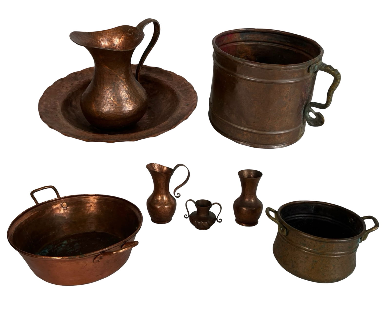 Group of Vintage Copper and Brass Vessels: Extensive assortment of vintage hand-hammered copper and brass vessels, including pitchers, ewers, handled pots, wash basins, and decorative vases. These pieces display beautiful aged patina, riveted