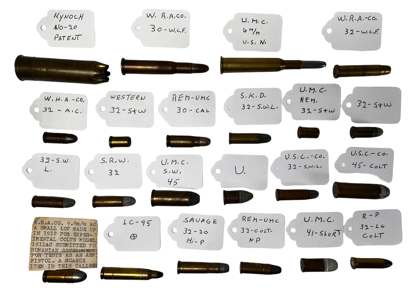 Lot of Antique & Vintage Ammunitin Cartridges: Remarkable group of over 30 vintage ammunition cartridges, each meticulously labeled with manufacturer and caliber, including examples from W.R.A. Co., U.M.C., Savage, Western, S.K.D., REM-UMC, and