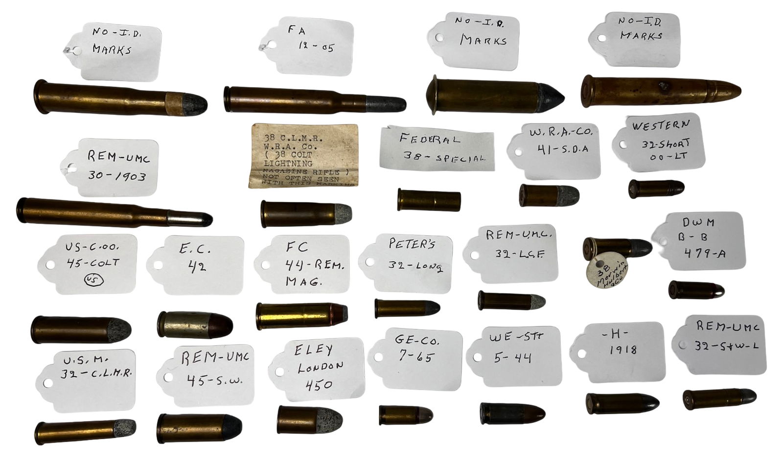 Vintage and Antique Ammunition Ammo Cartridges: Large curated assortment of vintage and antique ammunition cartridges, each with hand-labeled identification tags. Includes rounds marked REM-UMC, Peters, Western, W.R.A. Co., Federal, FC, Eley
