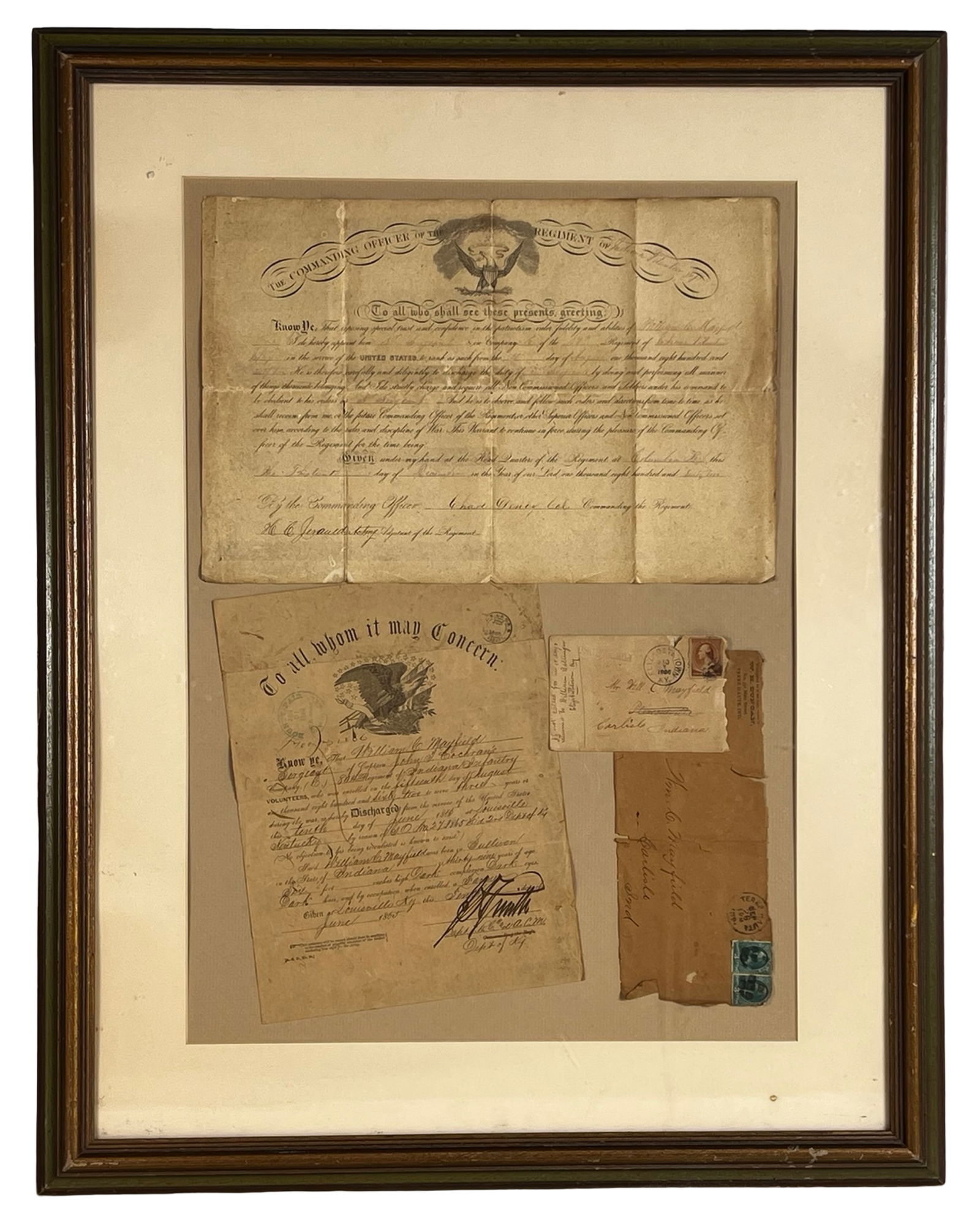 Antique Civil War Discharge & Commission Documents: Striking Civil War-era historical grouping framed under glass, measuring approximately 30" x 24", featuring a set of original documents and envelopes belonging to William C. Mayfield of the 28th