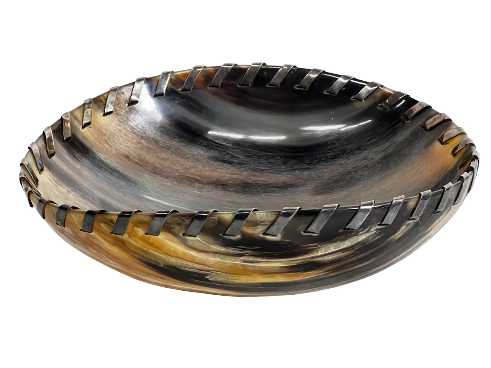 John Hardy Buffalo Horn Sterling Stitch Bowl: Elegant oval bowl crafted from polished buffalo horn with a hand-applied sterling silver stitch border. This collectible piece by John Hardy bears the designer's hallmark seal on the underside. A stri