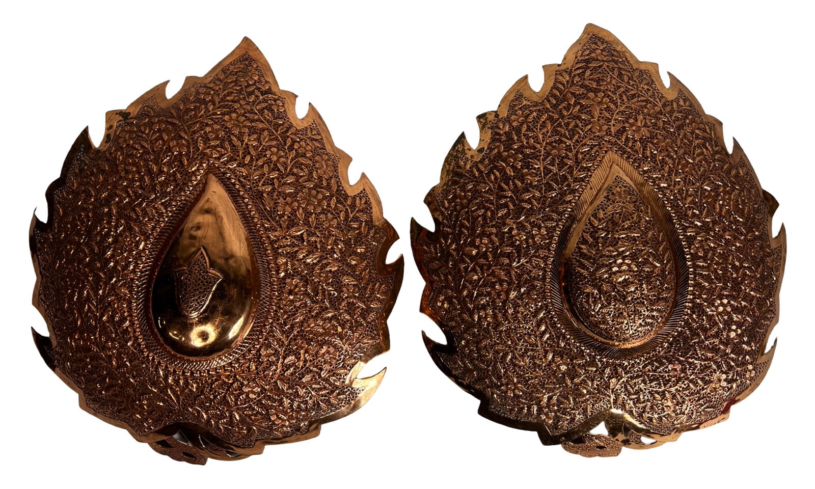 Pair of Large Middle Eastern Copper Wall Plaques: This striking pair of large Middle Eastern wall plaques is crafted from solid copper and richly decorated with intricate hand hammered detailing throughout. Each plaque features a dramatic leaf