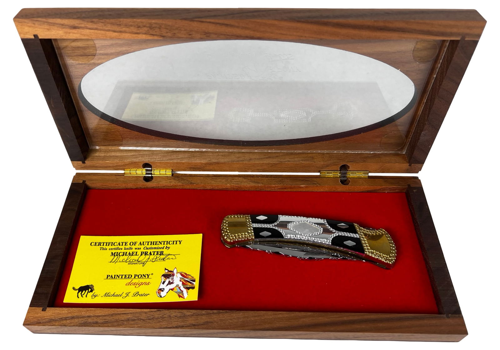 Michael J. Prater Painted Pony Buck Folding Knife: This finely crafted custom Buck folding knife was customized by Michael J. Prater of Painted Pony Designs and is presented in its original wooden display case with a Certificate of Authenticity. The