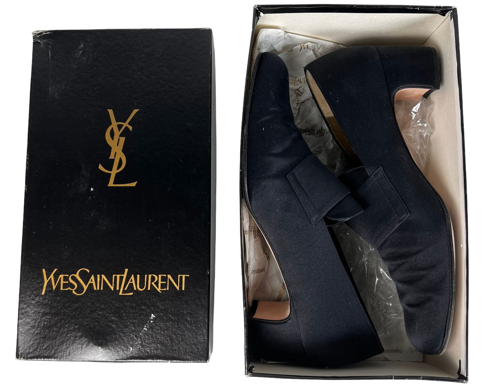 Yves Saint Laurent Black Slip-On Heeled Loafers: Classic Yves Saint Laurent women's slip-on loafers in black satin with a structured block heel and a clean, minimalist design featuring a front strap detail. These elegant shoes are marked size 9 &fra