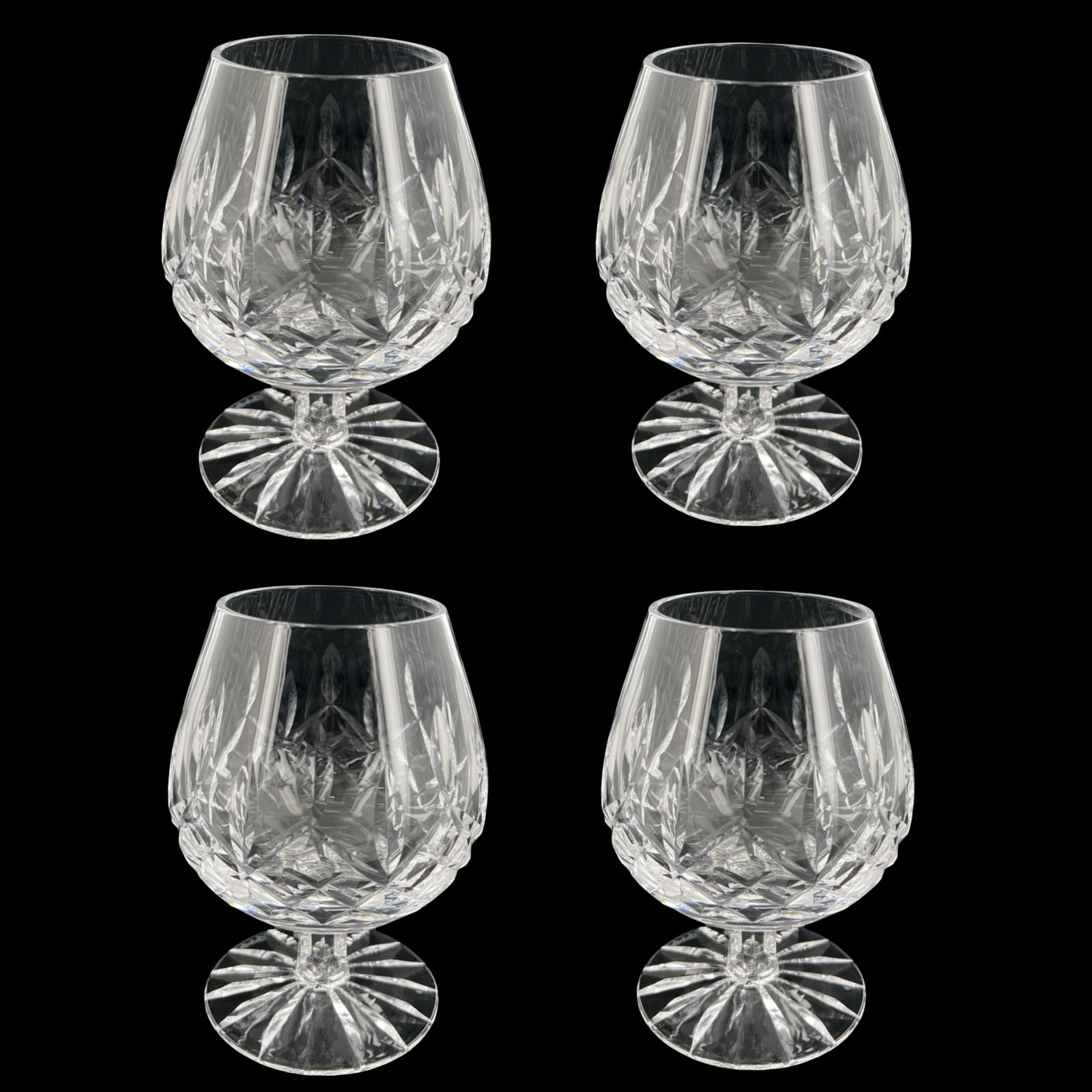 Waterford Lismore Crystal Brandy Snifter Glasses: Classic set of four Waterford Crystal balloon brandy snifter glasses in the iconic Lismore pattern. Each glass is beautifully cut with deep diamond and wedge motifs that enhance brilliance and