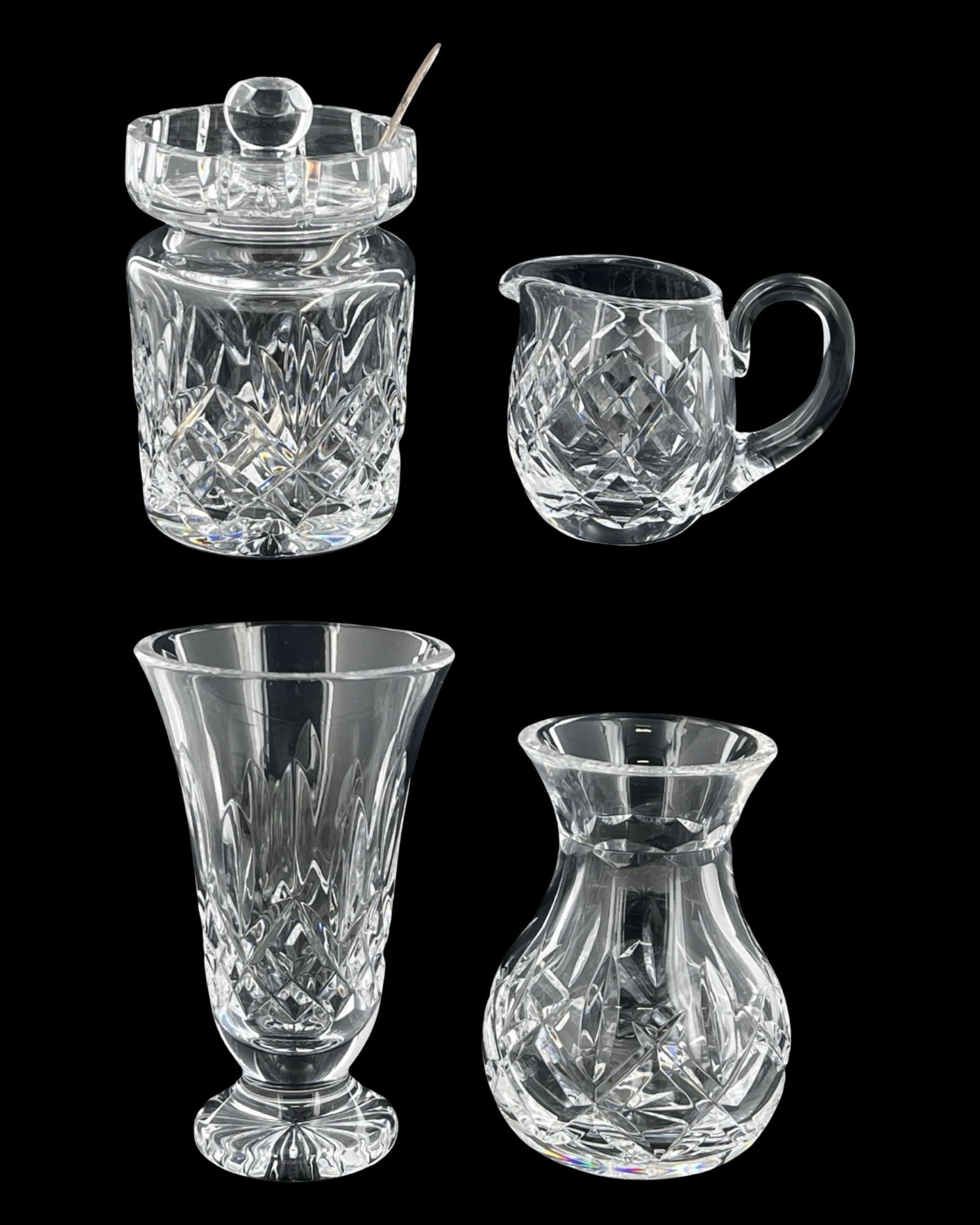 Waterford Lismore Cut Crystal Tableware Assortment: Elegant grouping of Waterford crystal in the classic Lismore pattern, showcasing the brand's signature deep diamond and wedge cuts. This assortment includes a Lismore creamer, a jam and honey jar