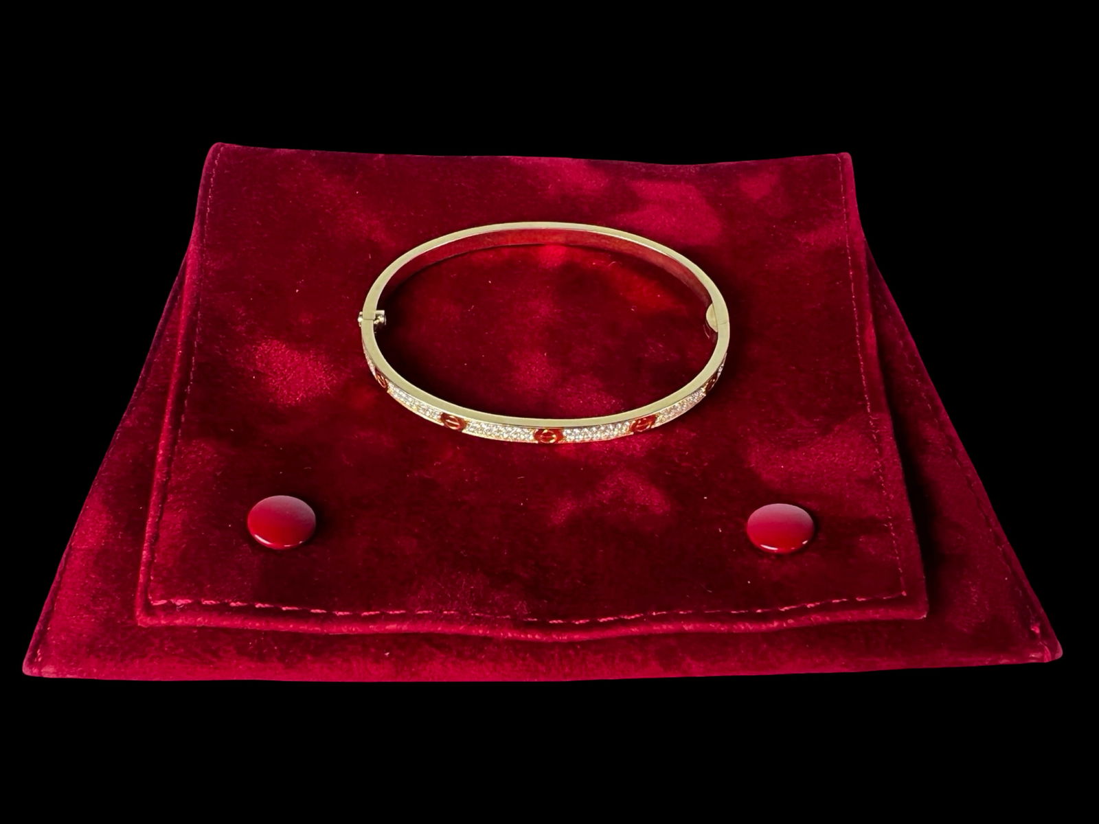 Cartier 18K Yellow Gold Pave Diamond Love Bracelet: Iconic Cartier Love bracelet crafted in 18K yellow gold, featuring the signature screw motif accented with pave-set diamonds around the exterior. The bracelet is stamped and hallmarked on the interior