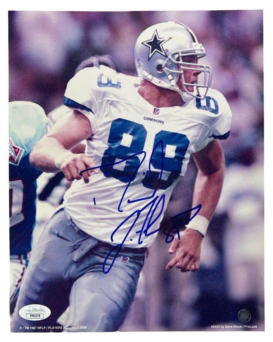 David LaFleur Signed Dallas Cowboys Photograph: Autographed action photograph of superstar Dallas Cowboys tight end David LaFleur. Captured in full stride during gameplay, this bold image is hand-signed in vibrant blue ink. A must-have for devoted