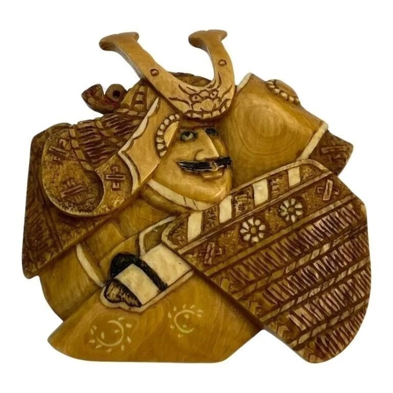 Japanese Artist Carved Bone Samurai Brooch/ Pin: This exceptional brooch/pin, crafted by a Japanese artist, is intricately carved from bone to depict a detailed Samurai warrior. The brooch measures 2 inches by 2 1/4 inches and features a silver clas