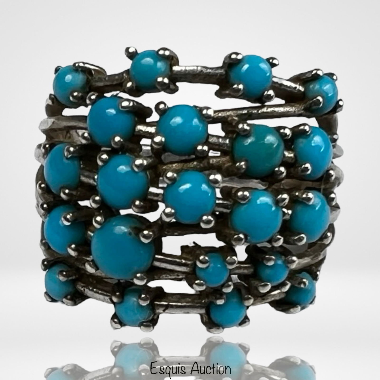 Sterling Silver Lady's Turquoise Cluster Ring: Striking vintage sterling silver ring featuring a bold multi-stone turquoise cluster design. The sculptural openwork band holds numerous round turquoise cabochons arranged in ascending rows, creating