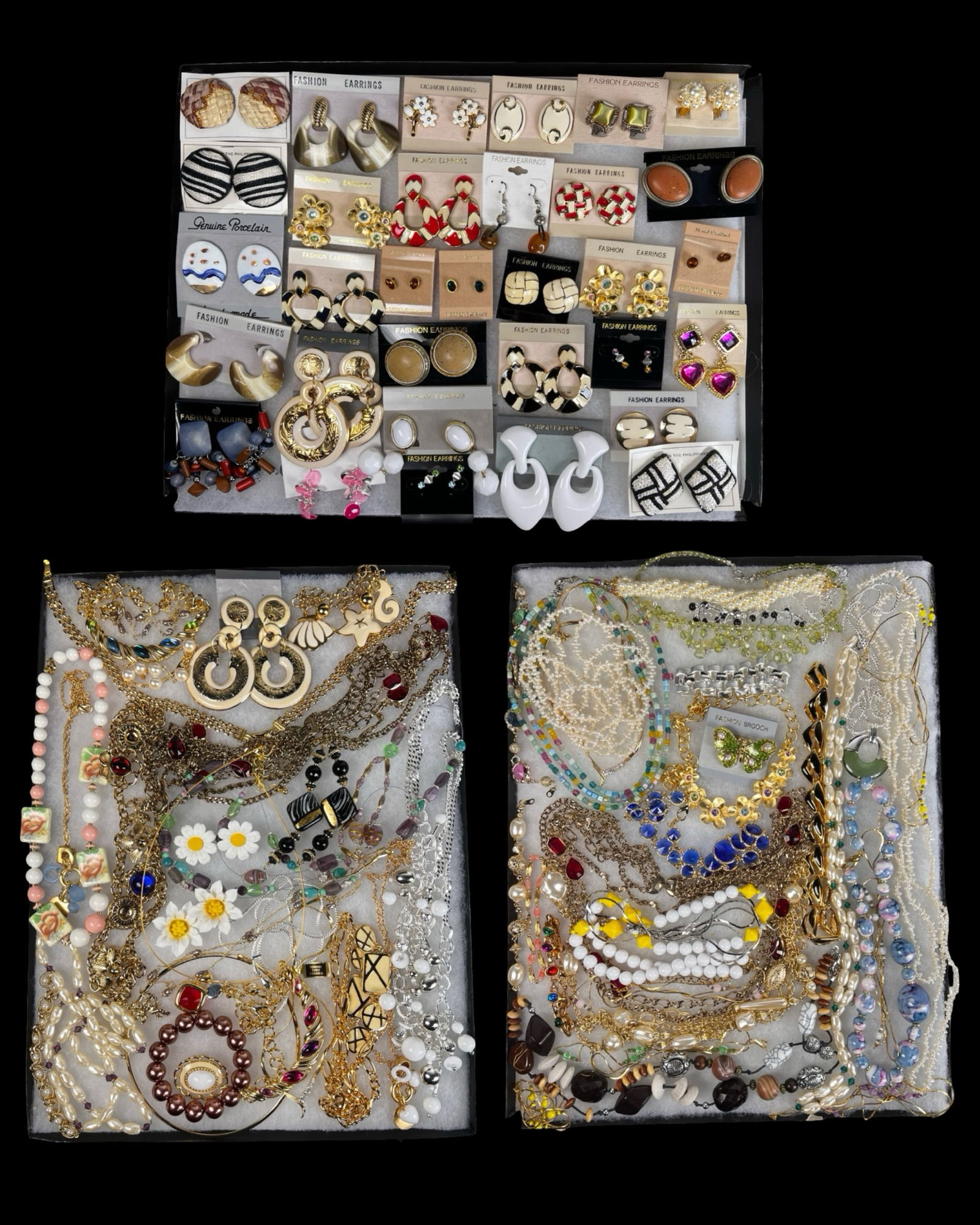 Large Assortment of Costume Jewelry: Colorful and varied assortment of costume jewelry featuring a wide mix of earrings, necklaces, bracelets, brooches, and decorative accents. Styles range from classic to bold statement pieces, with des