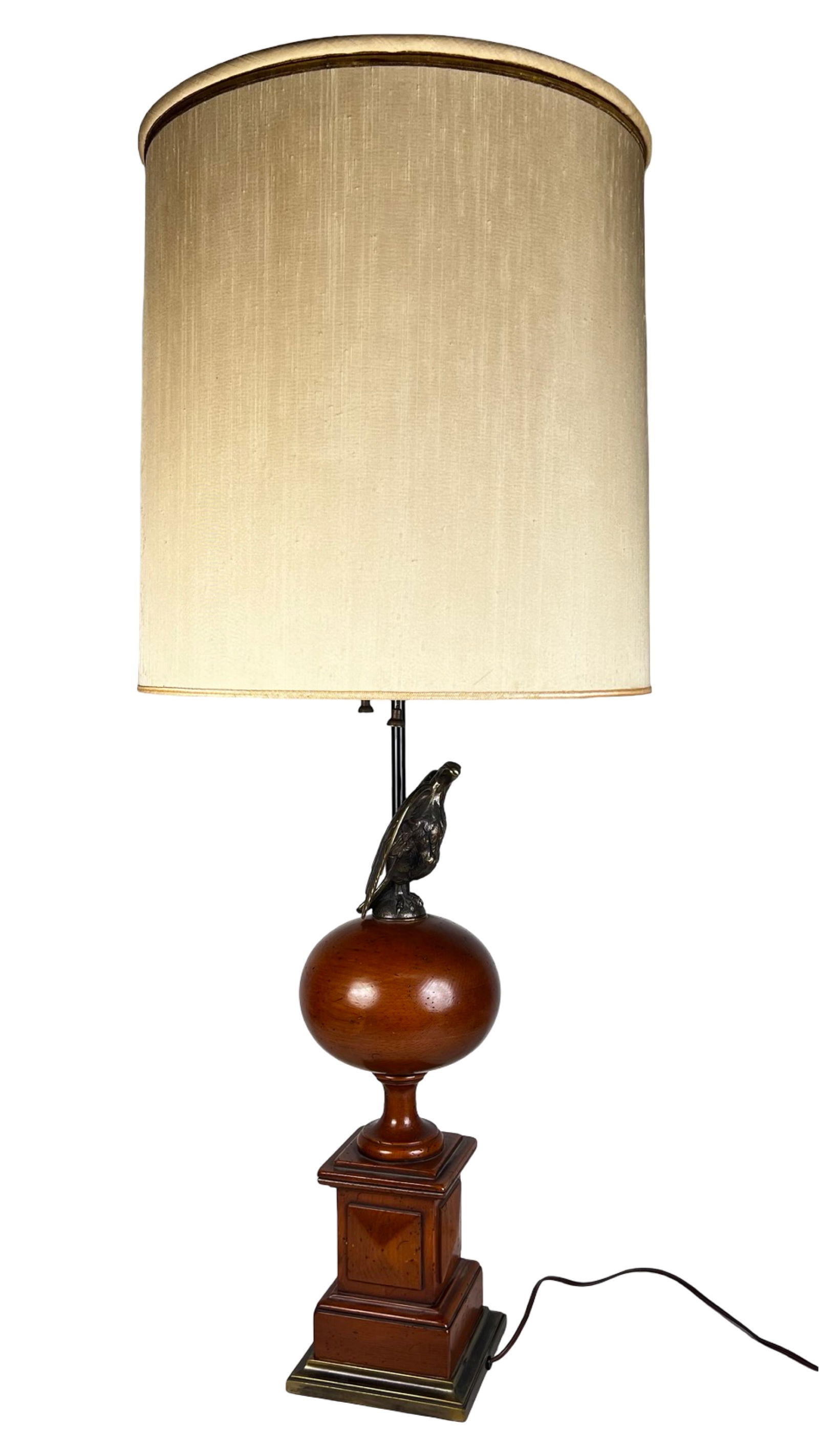 Mid Century Traditional Colonial Eagle Table Lamp: Striking Mid Century table lamp executed in a traditional Colonial Revival style, standing an impressive 41 inches tall. The design features a sculptural brass eagle with outstretched wings mounted ab