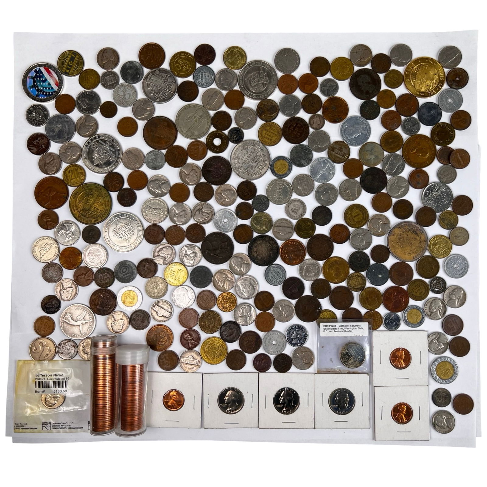 Assortment of World & US Coins and Tokens: Assortment of World & US Coins and Tokens. Including Two Tubes of 1963 and 1979 Copper Pennies. Unsearched.
