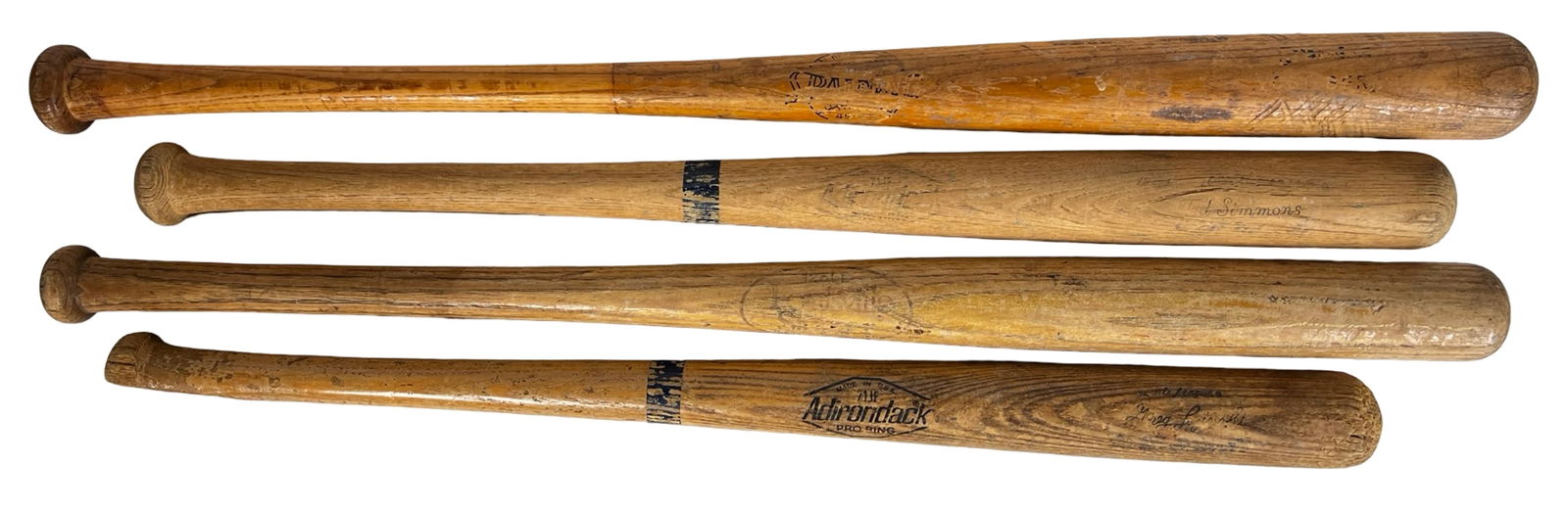 Four Vintage Player Model Wooden Baseball Bats: Group of four vintage wooden baseball bats featuring classic player-endorsed models from well-known manufacturers. This lot includes a Spalding Yogi Berra model bat, an Adirondack Ted Simmons model, a