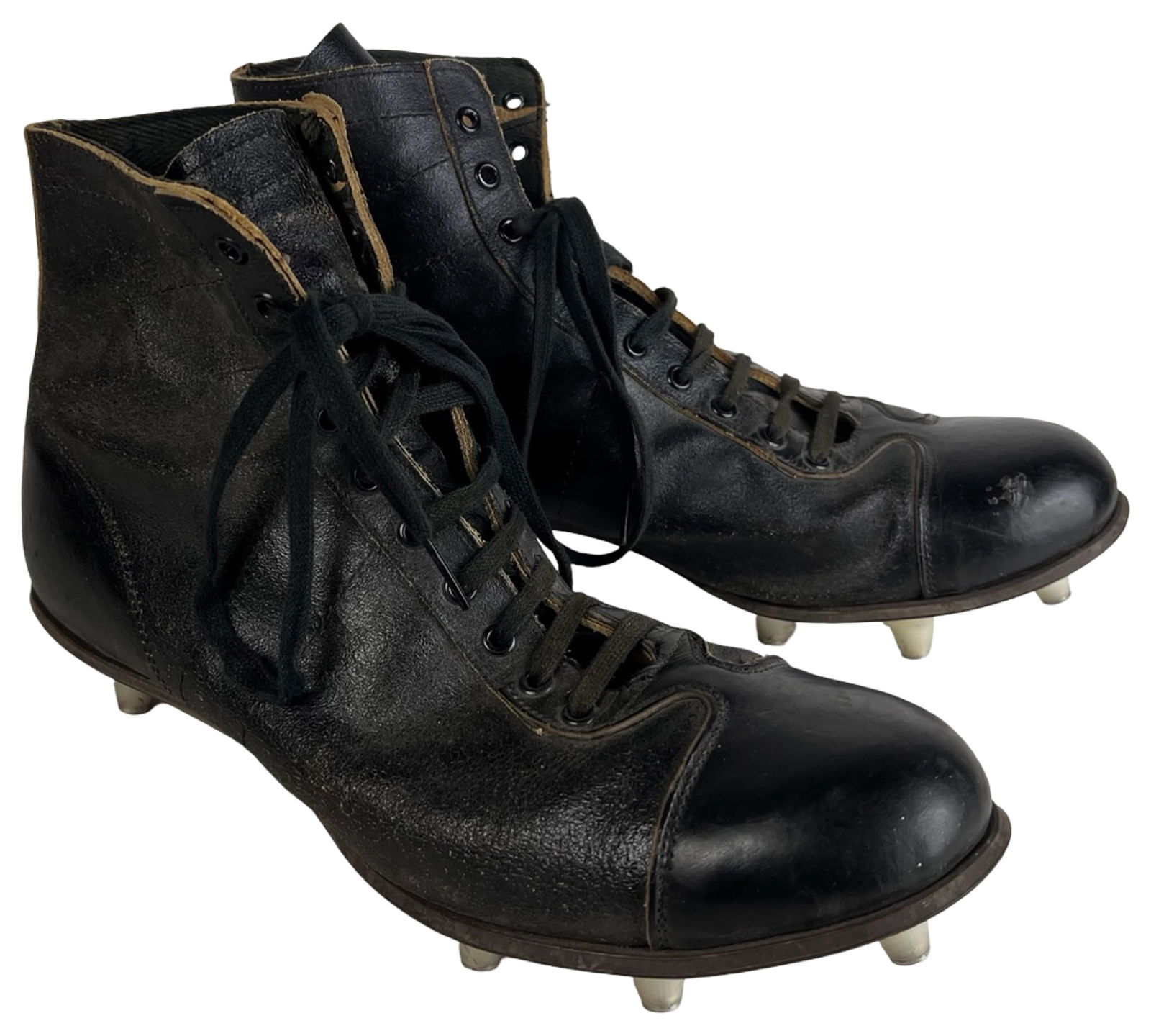 Vintage 1950s Sears Black Leather Football Cleats: Pair of vintage black leather football cleats by Sears, dating approximately to the late 1950s-mid 1960s. Classic high-top lace-up design with reinforced cap toes and stitched leather soles.The soles