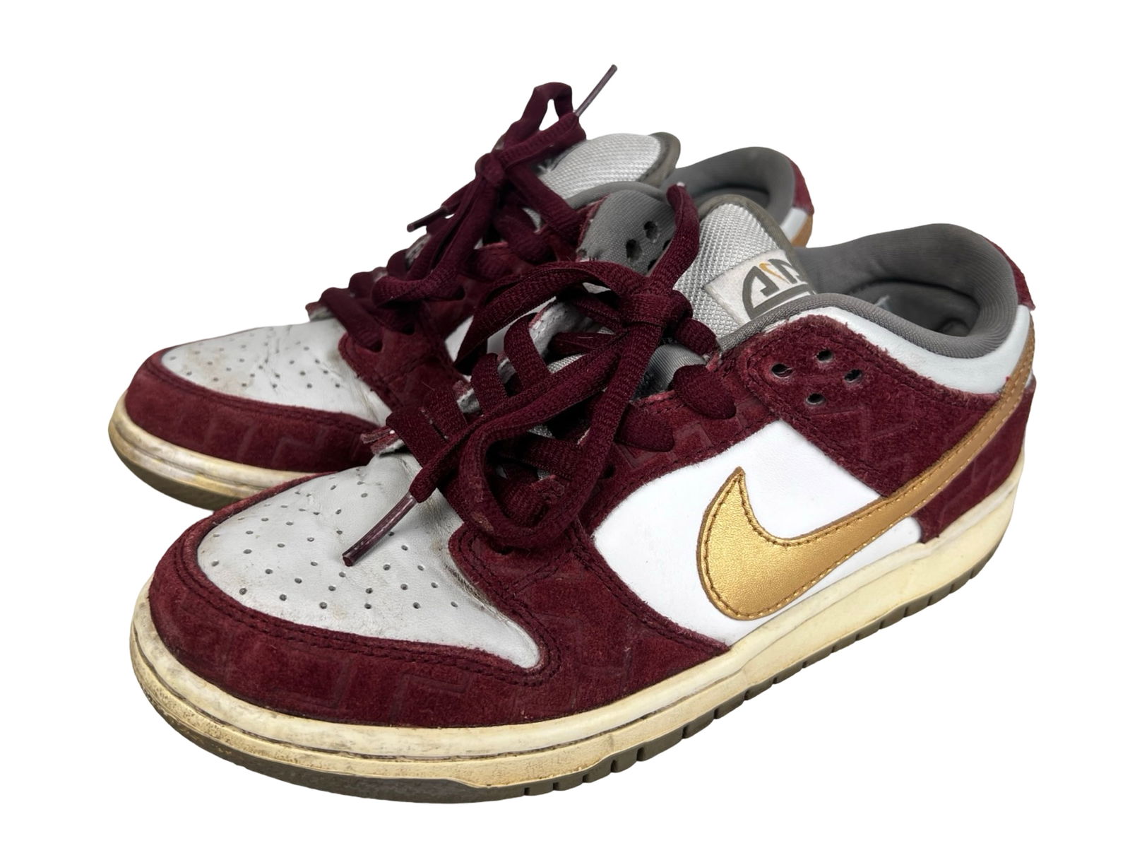 Nike Dunk Low Pro SB "Shanghai" Sneakers: Nike Dunk Low Pro SB "Shanghai" sneakers in size 6.5. This sought-after release features a burgundy suede overlay with subtle patterned detailing, white leather panels, and metallic gold Swoosh