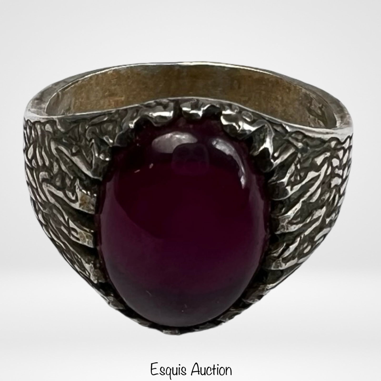 Sterling Silver Men's Ring with Red Agate Cabochon: Bold sterling silver ring featuring an impressive oval red agate cabochon set in a dramatic sculptural mounting. The stone displays a rich, deep red tone with subtle natural variation and a smooth