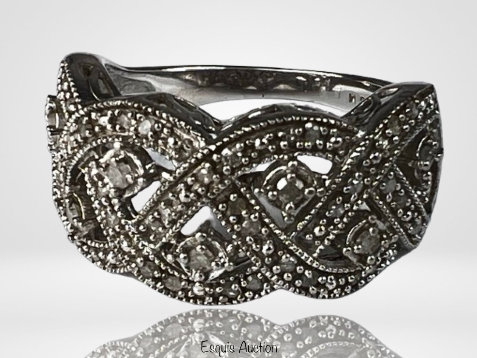 Lady's 0.33 CTW Diamond Sterling Silver Ring: Elegant sterling silver ring set with approximately 0.33 carat total weight of diamonds. The design features an intricate openwork pattern accented with round diamonds throughout, creating a refined,