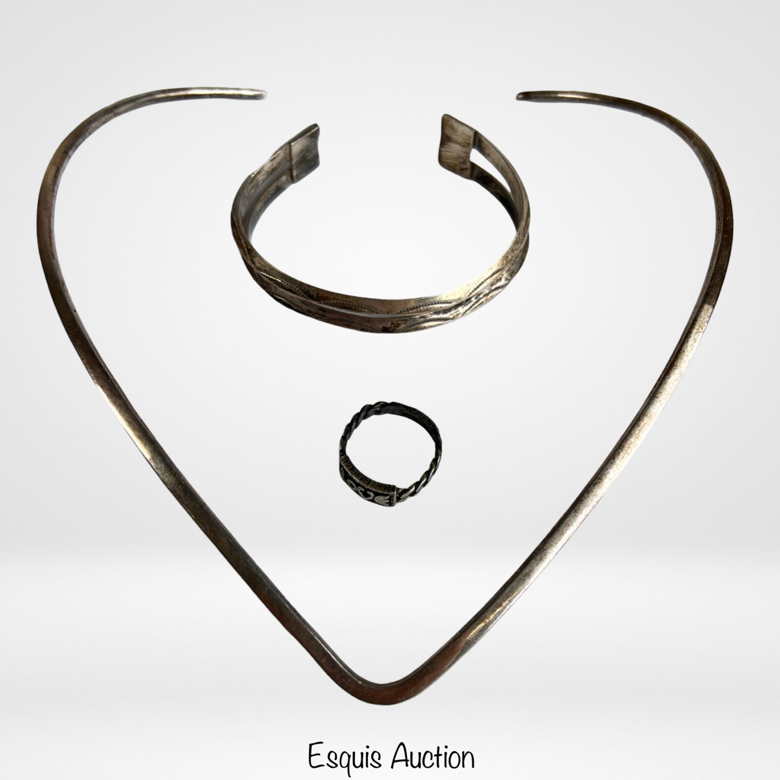 Sterling Silver Jewelry- Collar Necklace, Bracelet: Group of sterling silver jewelry including a size 6.5 ring with heart motif, an open cuff bracelet, and a V-form collar necklace.The bracelet measures approximately 2 3/4" x 2" x 1/2". The collar