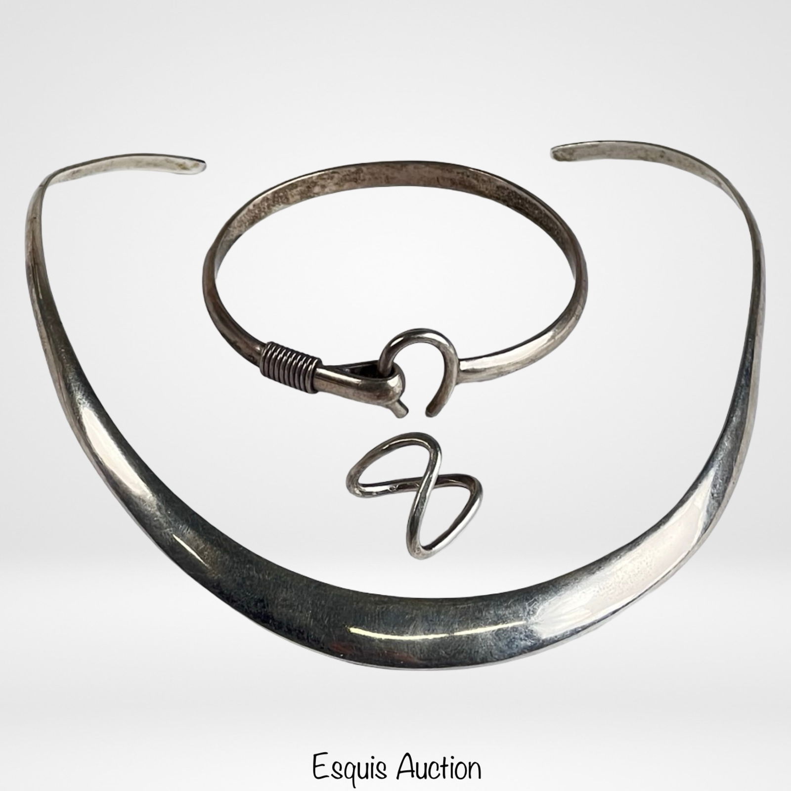 Modernist Sterling Silver Necklace, Bracelet & Rin: Modernist sterling silver trio featuring a bold crescent-form collar necklace, matching hook-closure bracelet, and an open double-loop sculptural ring. The necklace has a sleek, minimalist profile,