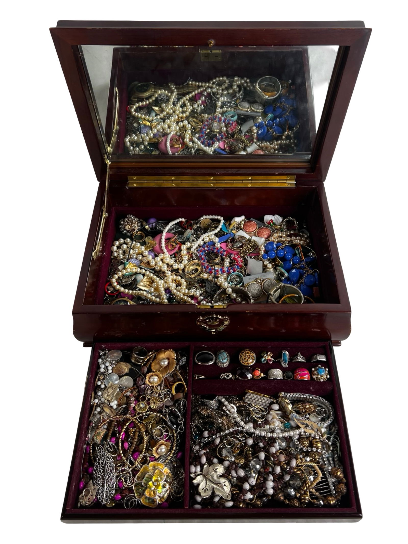 Vintage Jewelry Box Filled with Unsearched Jewelry: A charming vintage jewelry box featuring multiple compartments lined in rich red velvet, brimming with a variety of unsearched jewelry. This treasure trove includes an assortment of necklaces,
