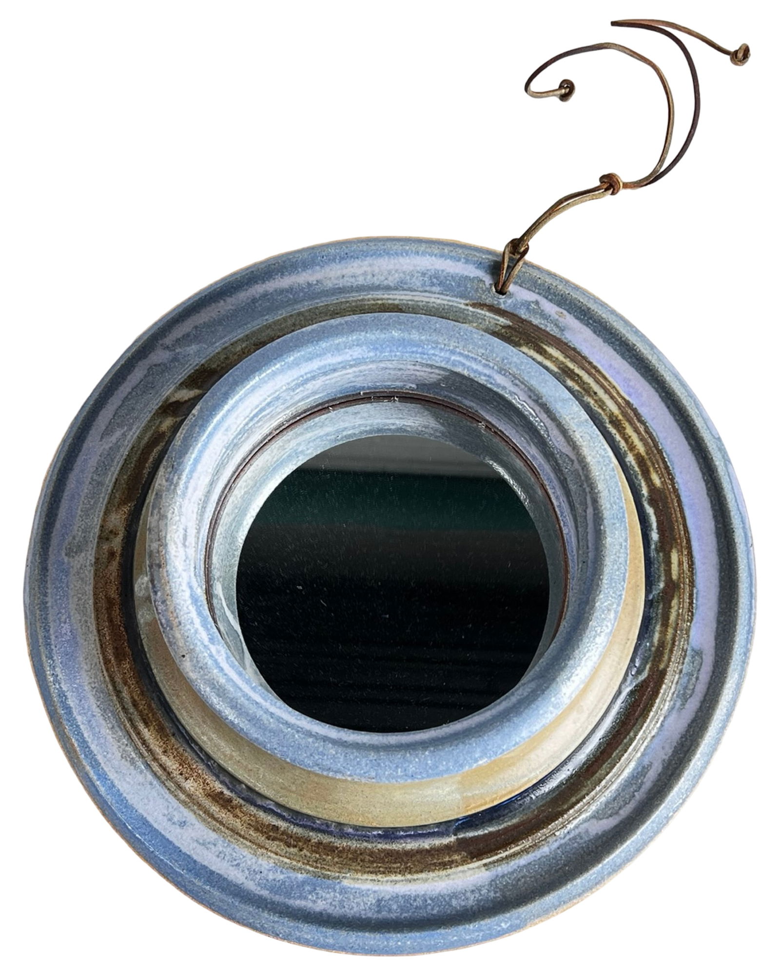 Art Pottery Glazed Stoneware Wall Mirror: Handcrafted art pottery wall mirror formed in substantial stoneware and finished in layered blue and earthy brown glazes. The circular frame features softly concentric bands with variegated glazing th