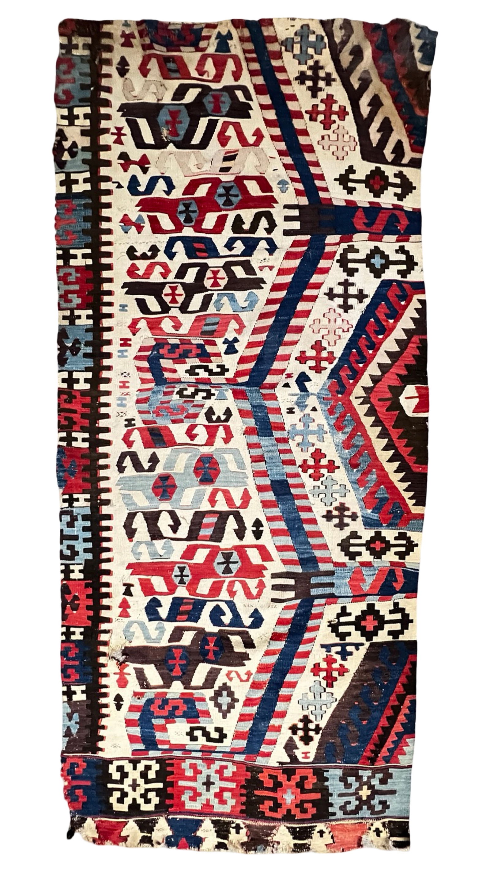 Antique Anatolian Kilim Rug- Turkey, Circa 1900: Antique Anatolian kilim from Turkey, dating to approximately 1900. This flat-woven textile features bold geometric motifs rendered in a striking palette of red, indigo blue, light blue, ivory, and bro