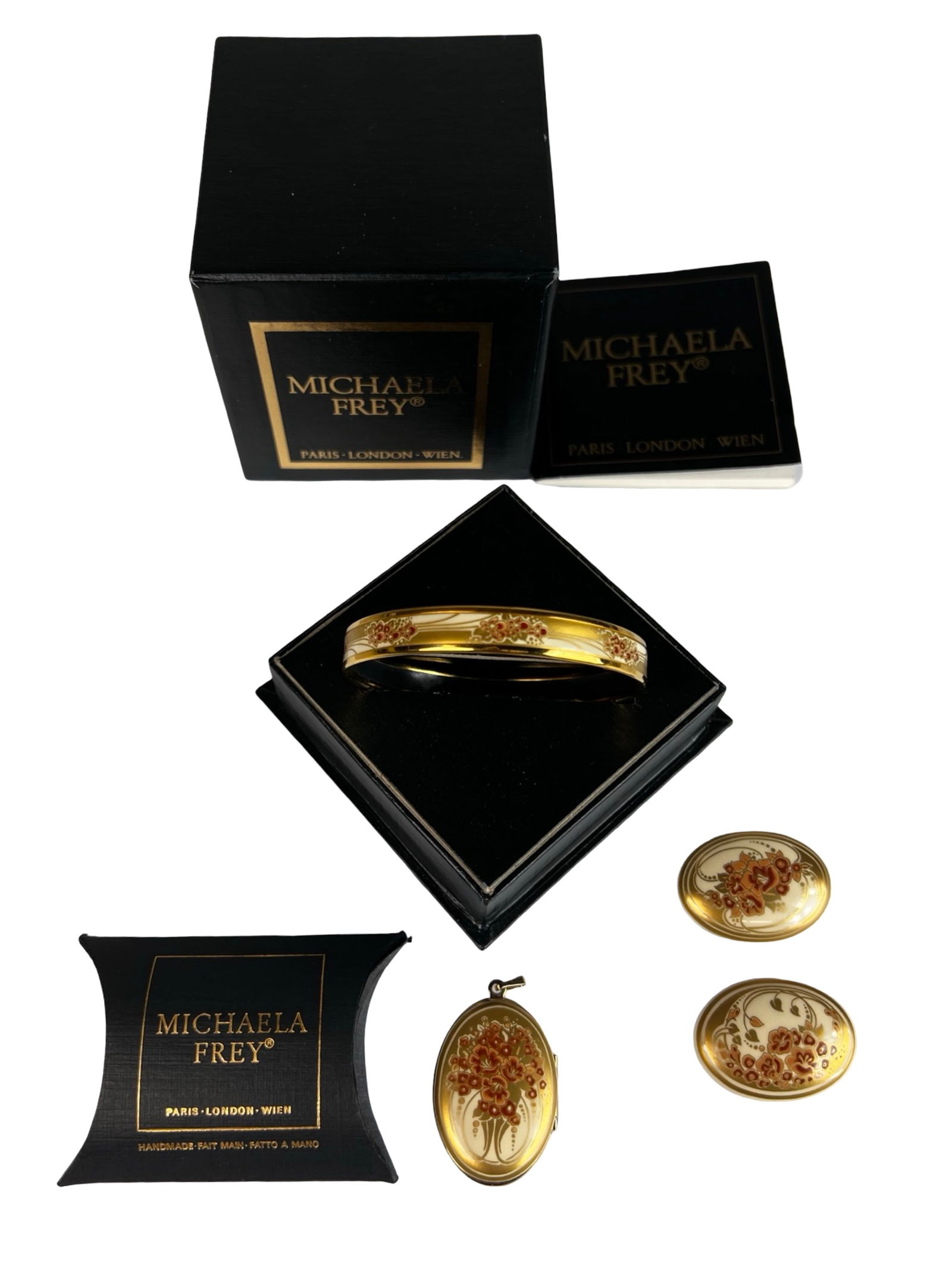 Michaela Frey Austria Enamel Jewelry Set: Elegant Michaela Frey enamel jewelry set made in Austria, featuring a coordinated gold-tone bangle bracelet, oval locket pendant, and two matching brooches. Each piece is decorated with a refined flor