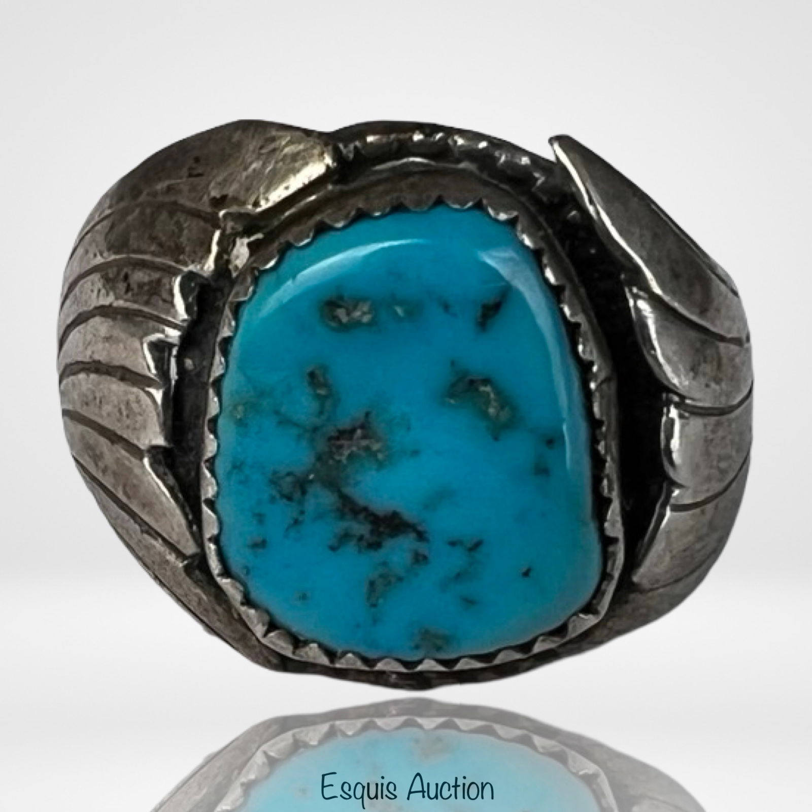 Massive Navajo Sterling Silver Turquoise Ring: Impressive Navajo sterling silver ring featuring a substantial natural turquoise cabochon set in a serrated bezel. The stone displays a vibrant blue hue with natural dark matrix throughout, giving it