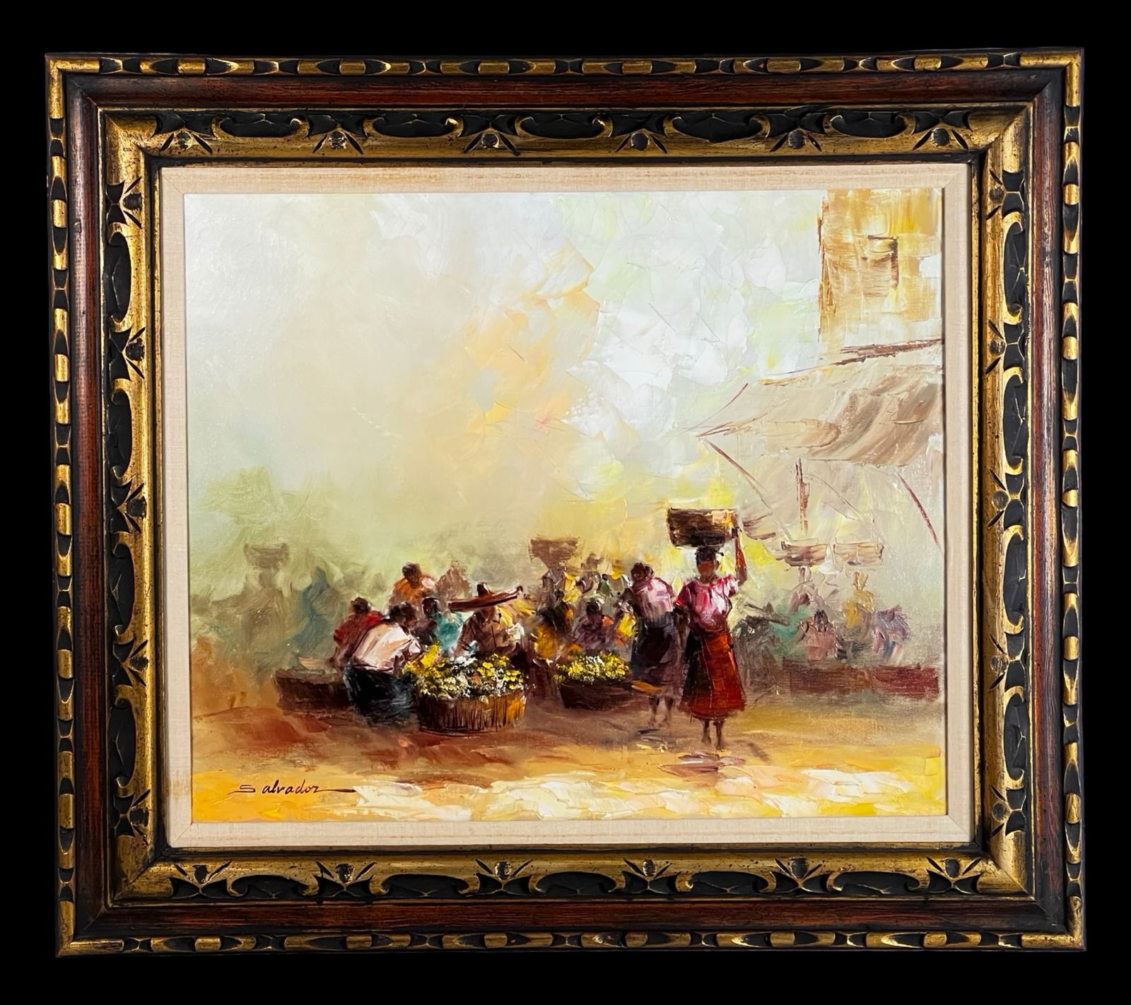 Market Scene Oil Painting by Salvador: Vibrant mid-century oil on canvas depicting a lively open-air market scene, signed "Slavador" lower left. The composition captures figures gathered around baskets of flowers and goods, with a central