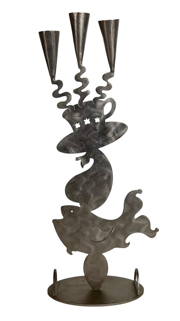 Amy Hess - Stainless Steel Candelabra Sculpture: Whimsical and imaginative, this figural candelabra sculpture by Amy Hess is crafted from stainless steel in a surreal, abstract form. The design features a playful fish balancing a swirling top hat an