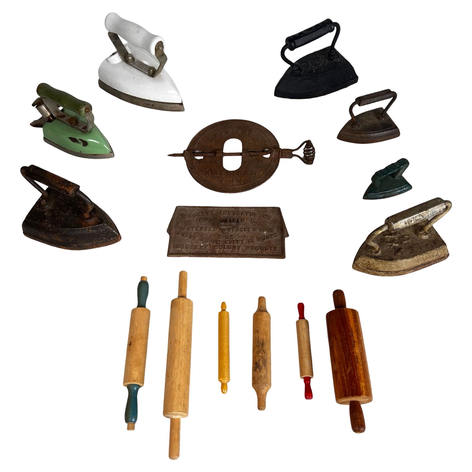 Antique Cast Iron Sad Irons & Rolling Pins: Eclectic collection of antique and vintage household primitives including cast iron sad irons, an early Griswold "New American" 7 in. cast iron flue damper (marked Erie, PA, U.S.A.), an antique