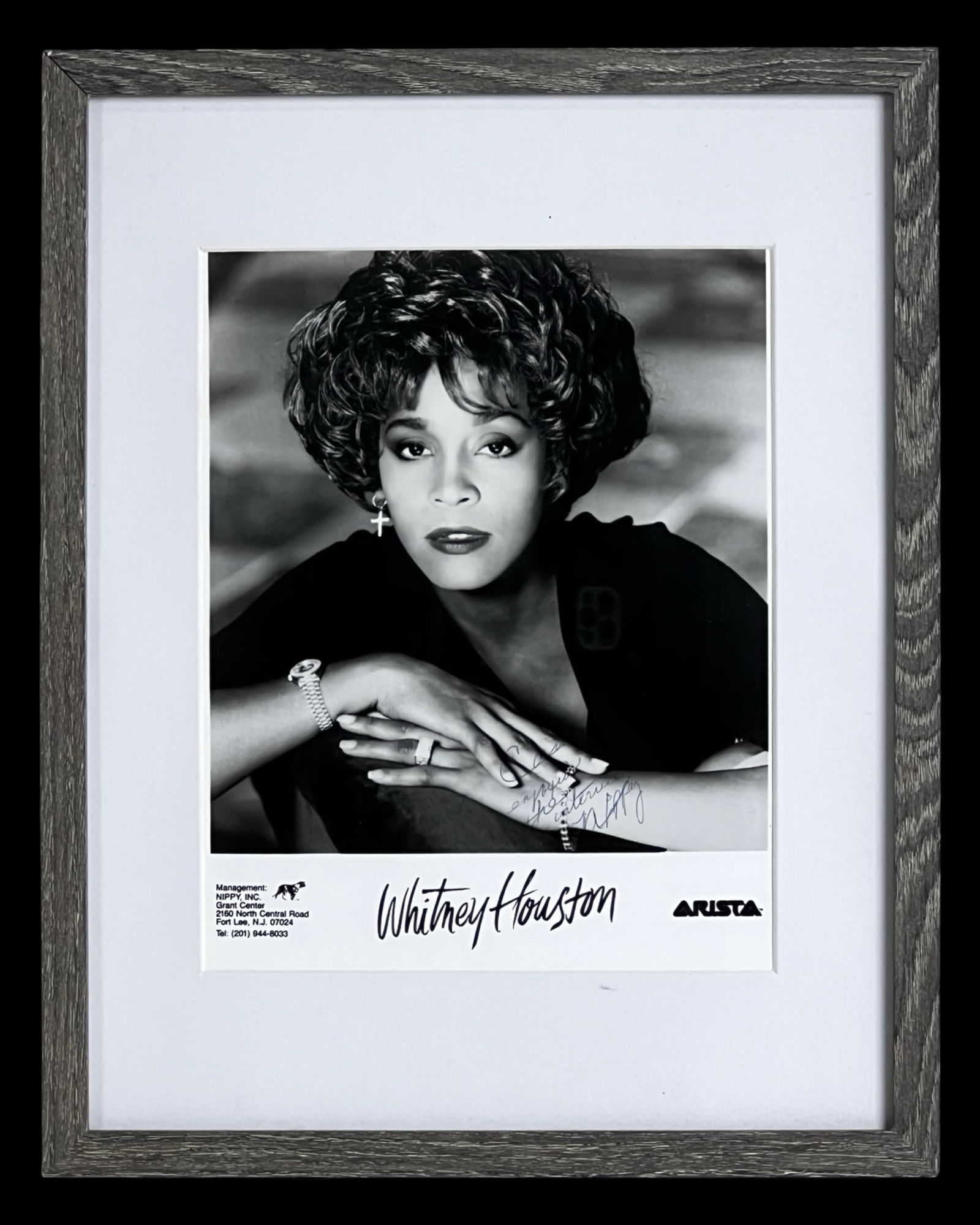Whitney Houston Autographed/ Signed Photograph: Black and white promotional portrait of Whitney Houston, signed in blue ink with personalized inscription.Photo measures 8 x 10 inches and is matted and framed to approximately 15 x 12 inches