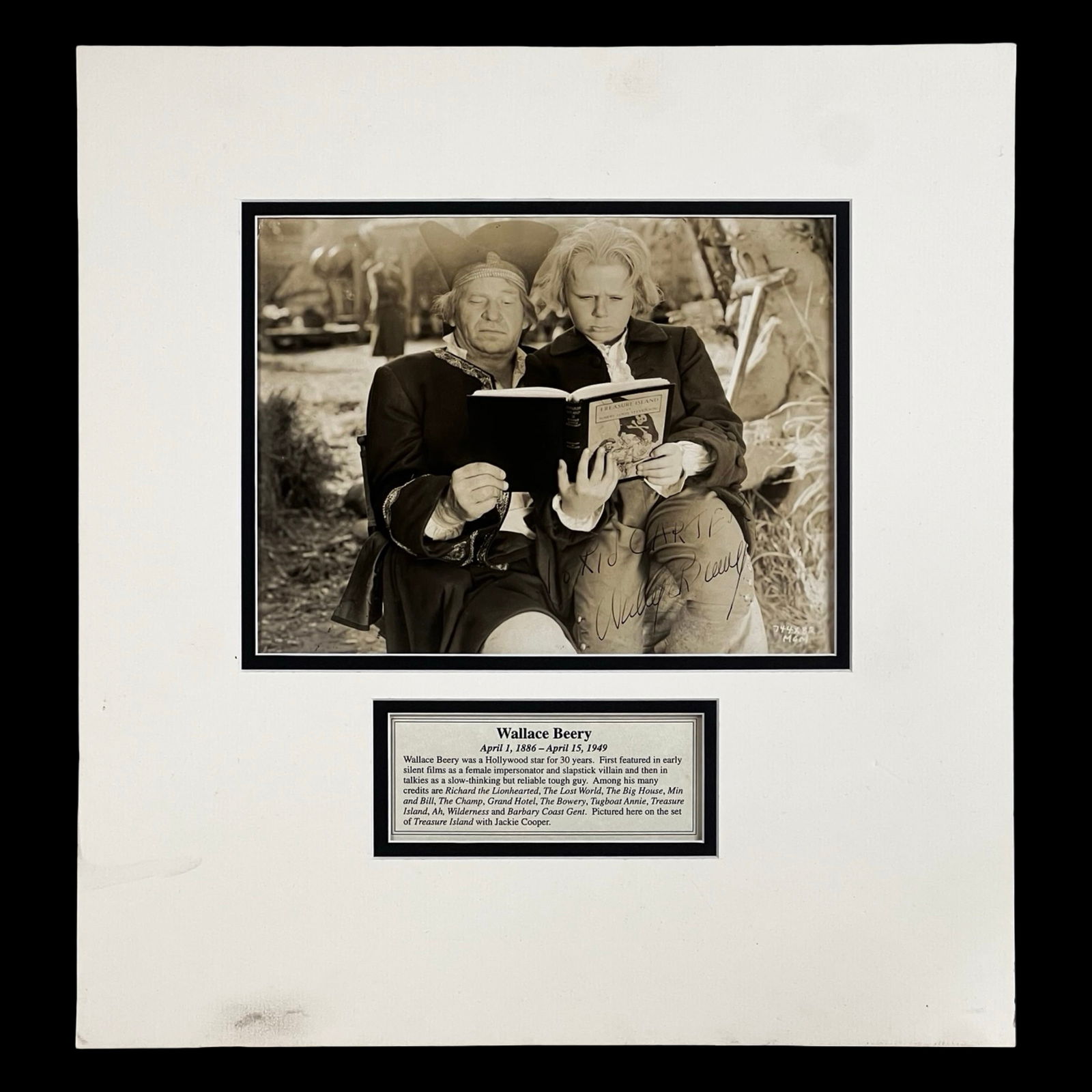 Wallace Beery Signed Treasure Island Photograph: Vintage sepia-tone photograph featuring Wallace Beery in his iconic role as Long John Silver from Treasure Island, boldly inscribed and signed across the image. A classic Hollywood autographed