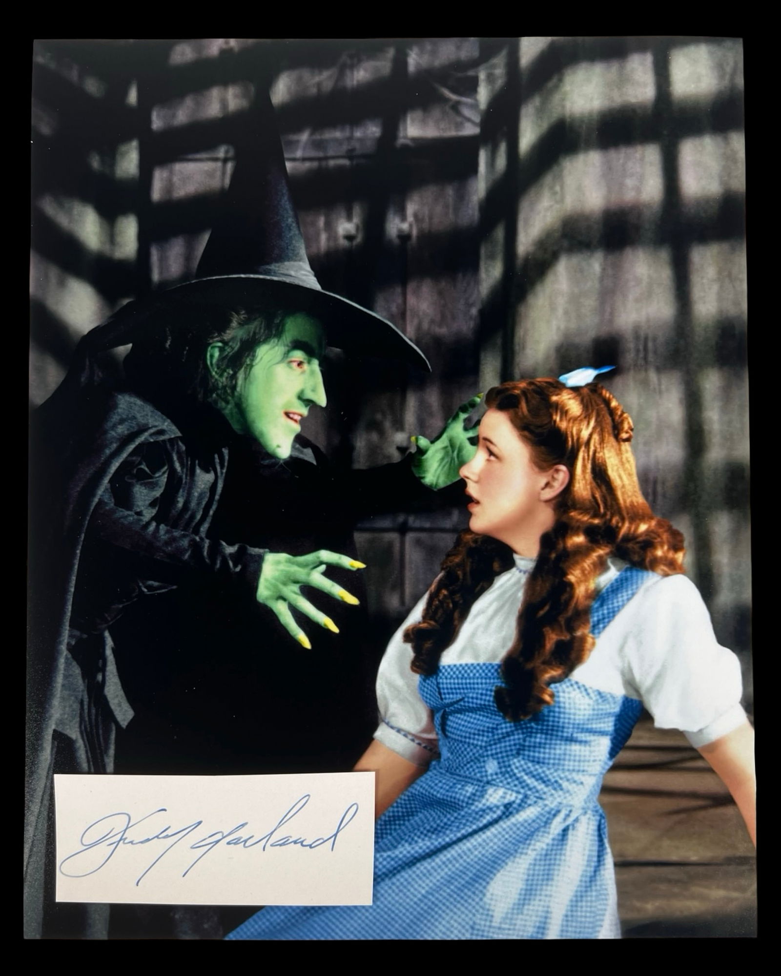 Judy Garland Autograph w/ Wizard of Oz Photo: Capture the magic of "The Wizard of Oz" with this Judy Garland Signature/ Autograph Cut paired with an iconic 8" x 10" photograph. The legendary Judy Garland, known for her unforgettable portrayal