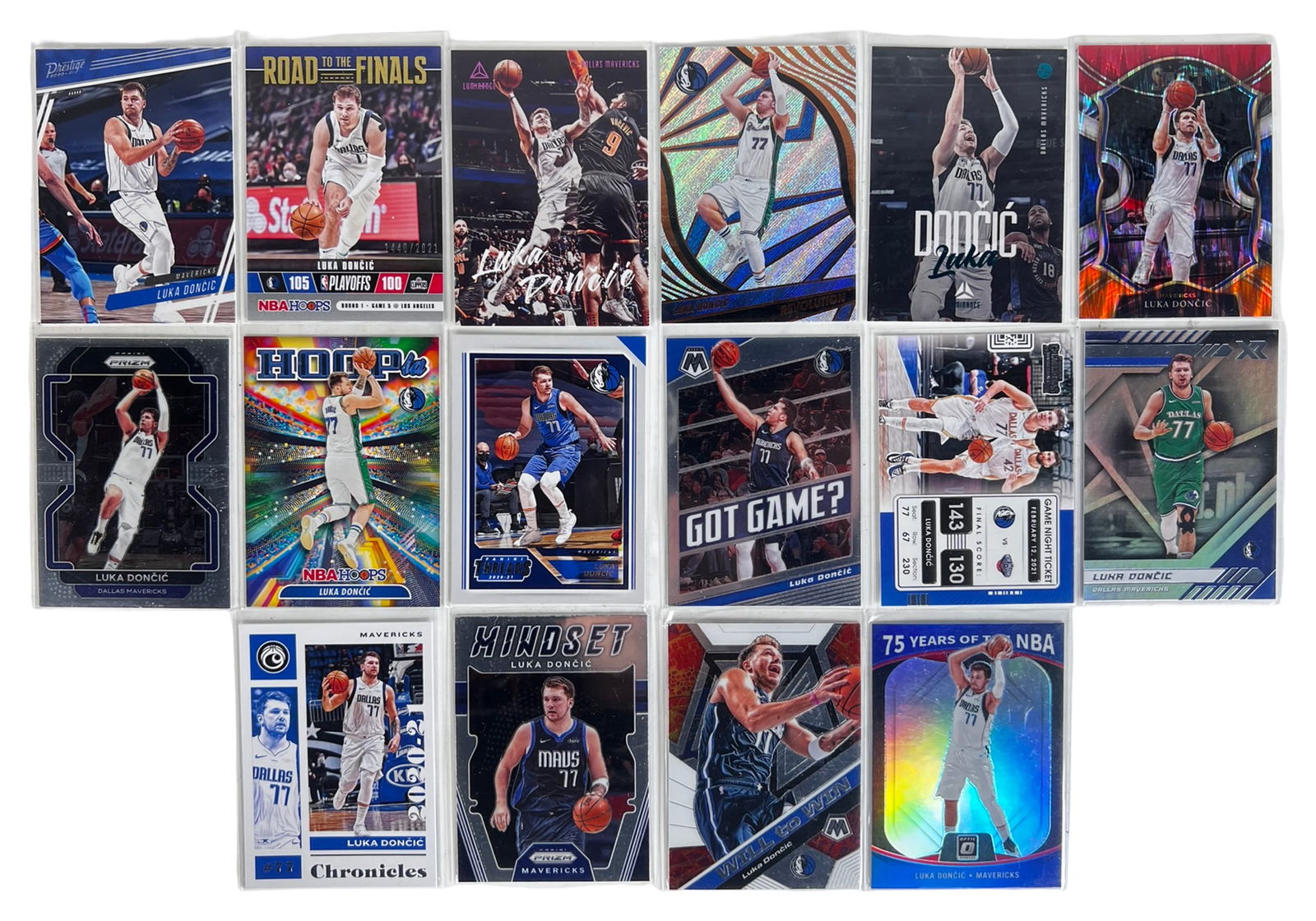 Luka Doncic Basketball Card Collection: Collection of Luka Doncic basketball cards featuring a variety of Panini releases and insert designs. Cards showcase Doncic in multiple Dallas Mavericks uniforms and action poses, with a mix of base