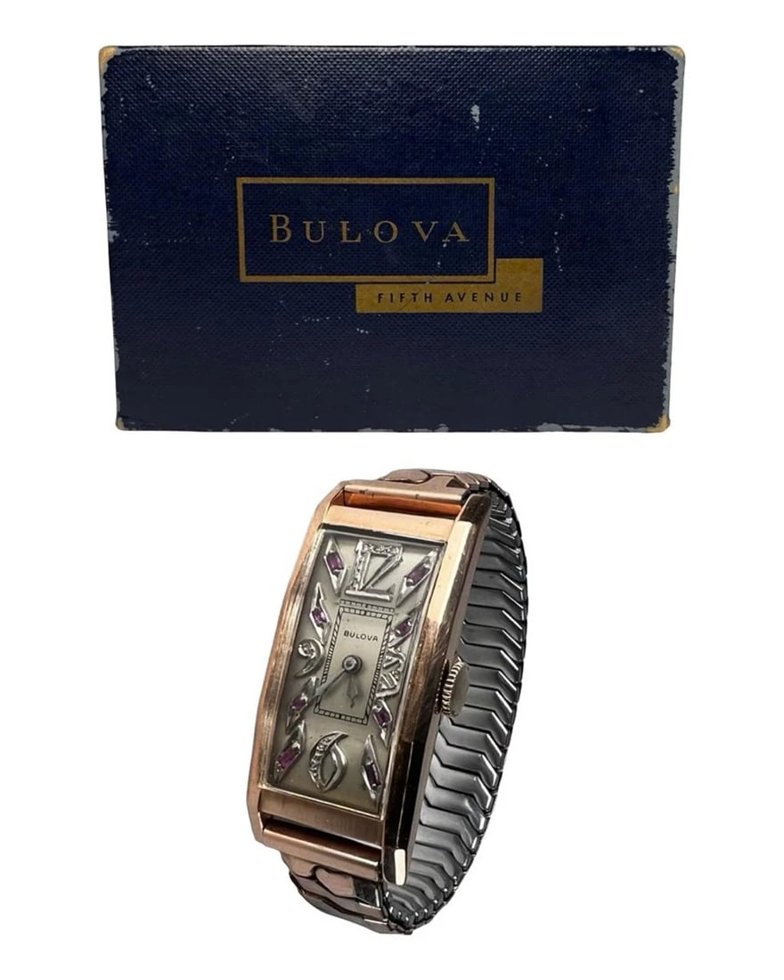14K Gold Bulova Art Deco Wristwatch w/ Ruby & Diam: Elegant Art Deco Bulova wristwatch featuring a rectangular 14K gold case with a decorative dial set with ruby and diamond accents. The stylized dial displays applied Arabic numerals and geometric