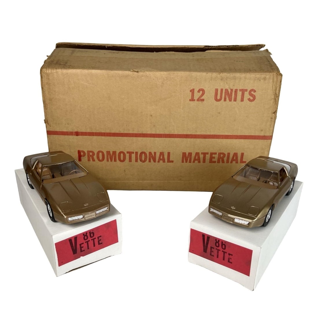 1986 Chevrolet Corvette Dealer Promotional Cars: Original 1986 Chevrolet Corvette dealer promotional models distributed by General Motors for showroom display and customer giveaways. This lot includes a factory box of 12 metallic gold Corvette model
