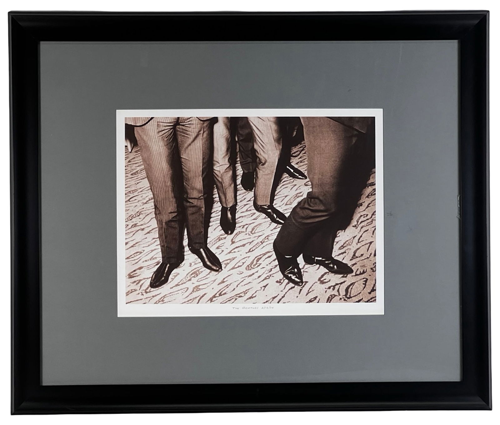 The Beatles 2/13/64 Photograph - Hard Rock Hotel: Iconic photograph depicting the lower half of The Beatles walking together, capturing the polished shoes and tailored suits that became synonymous with the band's early 1960s image. The composition em