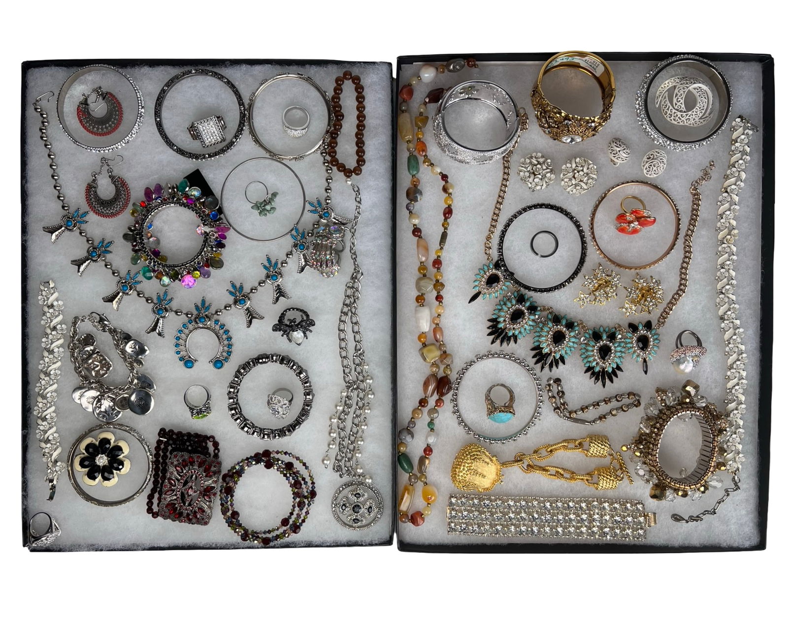 Large Assortment of Costume Jewelry: Large and visually appealing assortment of costume jewelry featuring a wide variety of necklaces, bracelets, rings, brooches, and earrings in assorted styles and materials. The group includes pieces