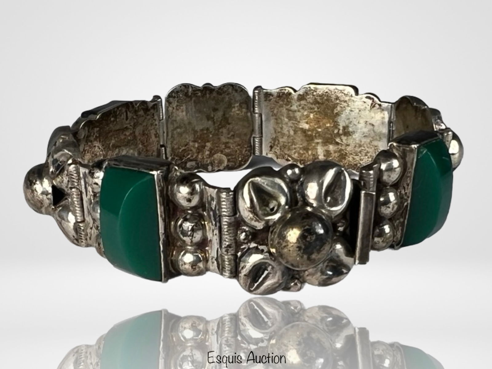 Vintage Sterling Silver & Green Onyx Bracelet: Elegant vintage sterling silver panel bracelet featuring articulated links set with rectangular green onyx cabochons. The design is highlighted by sculptural silver beadwork and raised decorative