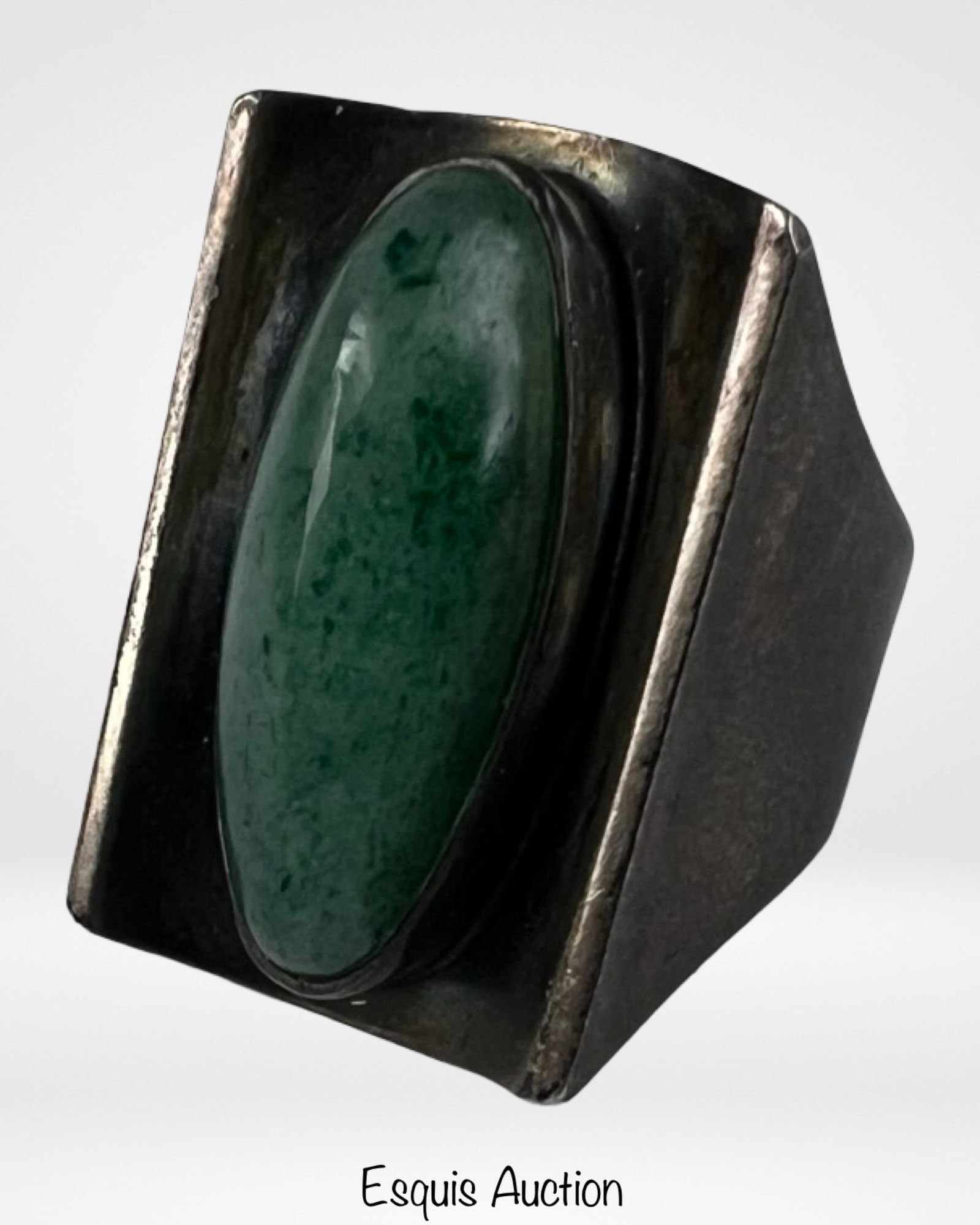 Modernist Sterling Silver Ring - Green Aventurine: Bold mid-century modernist sterling silver ring featuring a large oval green aventurine cabochon set within a sculptural geometric frame. The wide, architectural silver setting emphasizes the smooth