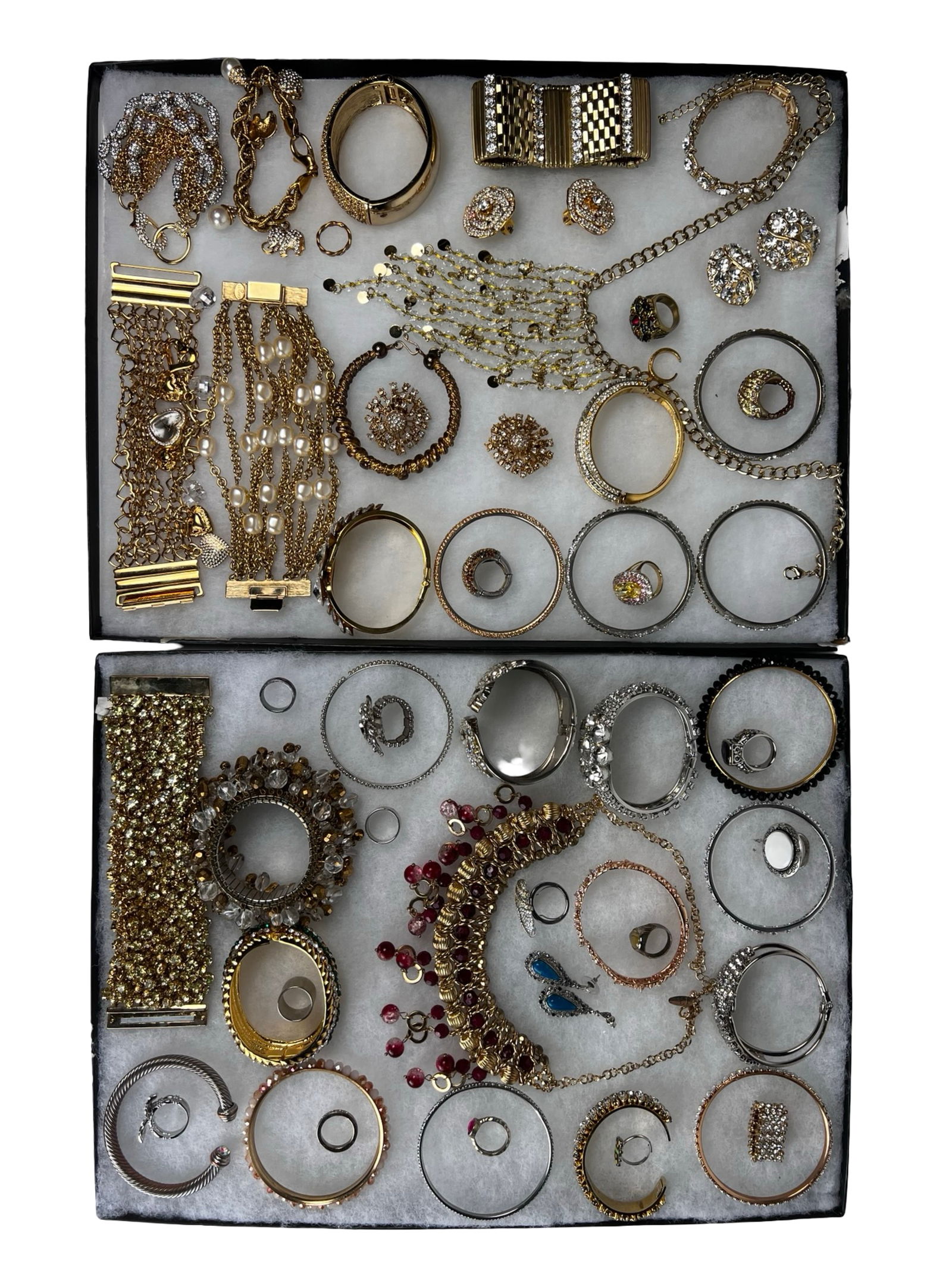 Fashion & Designer Costume Jewelry Assortment: Large assortment of fashion and designer-style costume jewelry featuring a variety of bracelets, bangles, rings, necklaces, earrings, and decorative pieces. The group includes rhinestone-set items,