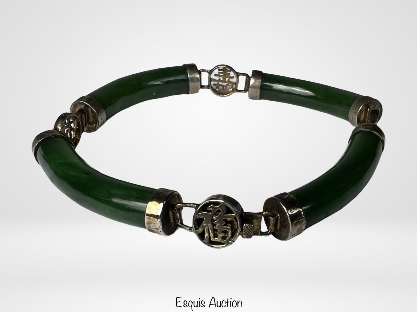 Chinese Sterling Silver Green Jade Link Bracelet: Elegant Chinese sterling silver bracelet composed of curved green jade segments joined by silver fittings and decorative round links featuring traditional Chinese longevity symbols. The polished jade