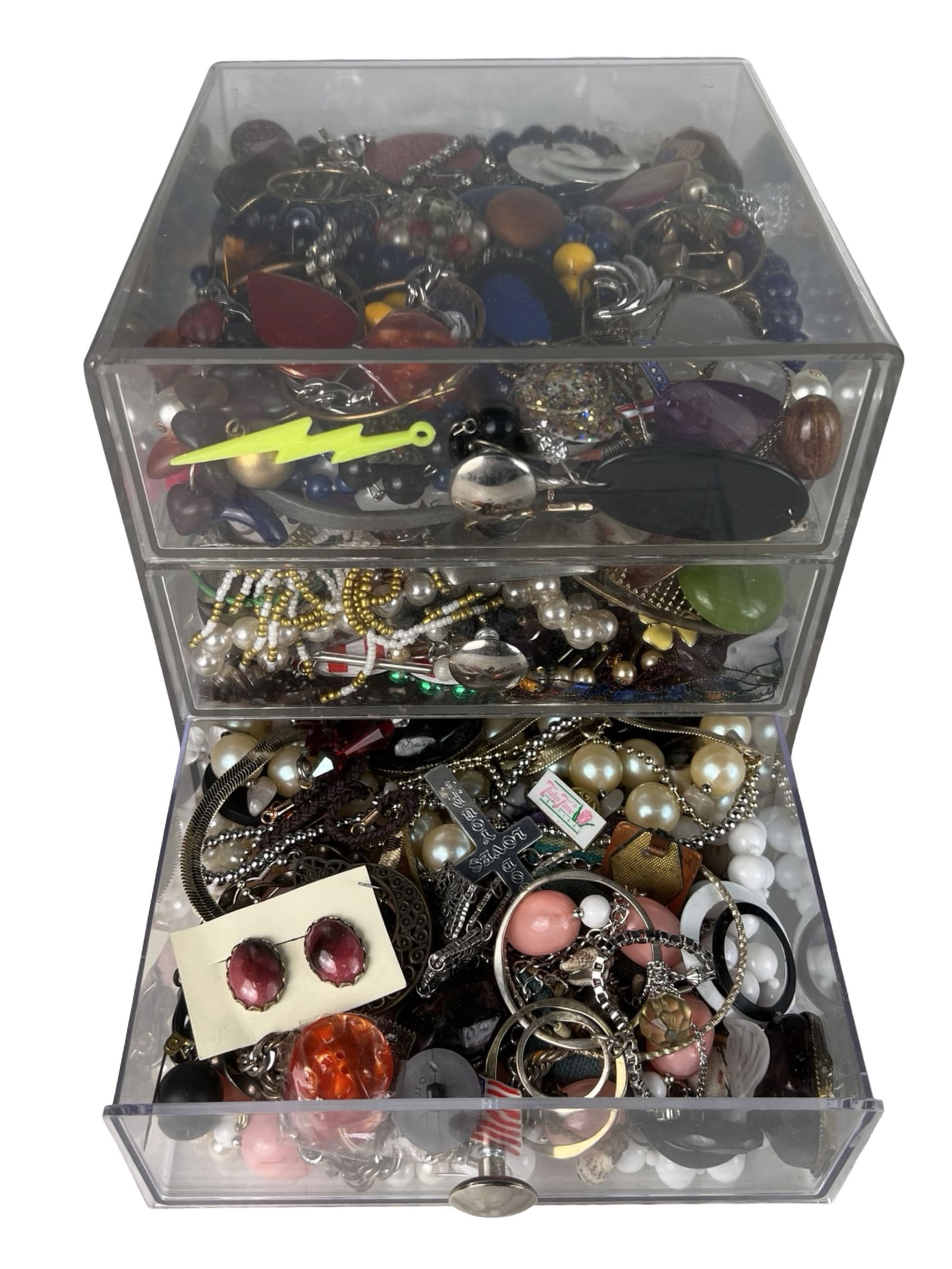Box filled with Vintage Unsearched Costume Jewelry: A charming assortment of vintage, unsearched costume and craft jewelry awaits, filled with creative potential and nostalgic appeal. The collection offers a wide variety of styles, colors, and