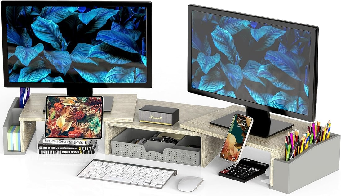 Lot of 2 NiB Dual Monitor Desk Stand Risers: Lot of two Simple Houseware dual monitor desk stand risers in a maple finish, designed to elevate computer monitors while creating additional desktop storage space. These risers help improve