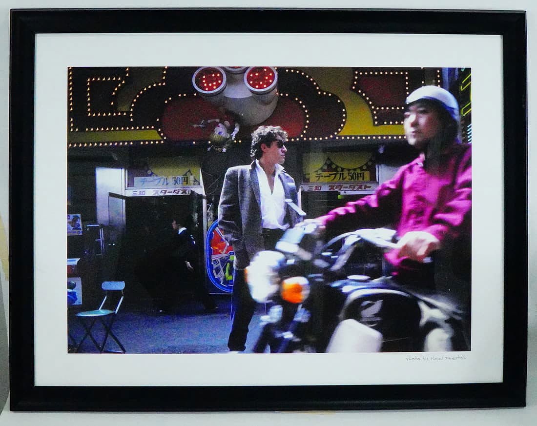 Bruce Springsteen Photo by Neal Preston Hard Rock: Color photograph capturing Bruce Springsteen during his visit to Kyoto, Japan in 1985, taken by renowned rock photographer Neal Preston. The image presents Springsteen in a candid street scene