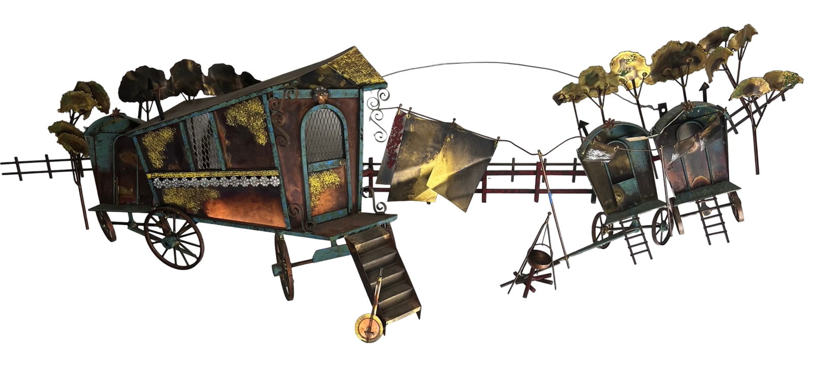 Curtis Jere Gypsy Camp Mixed Metal Wall Sculpture: Highly detailed Curtis Jere mixed metal wall sculpture titled "Gypsy Camp," depicting a whimsical caravan scene with traveling wagons set along a rural landscape. The composition features multiple dim