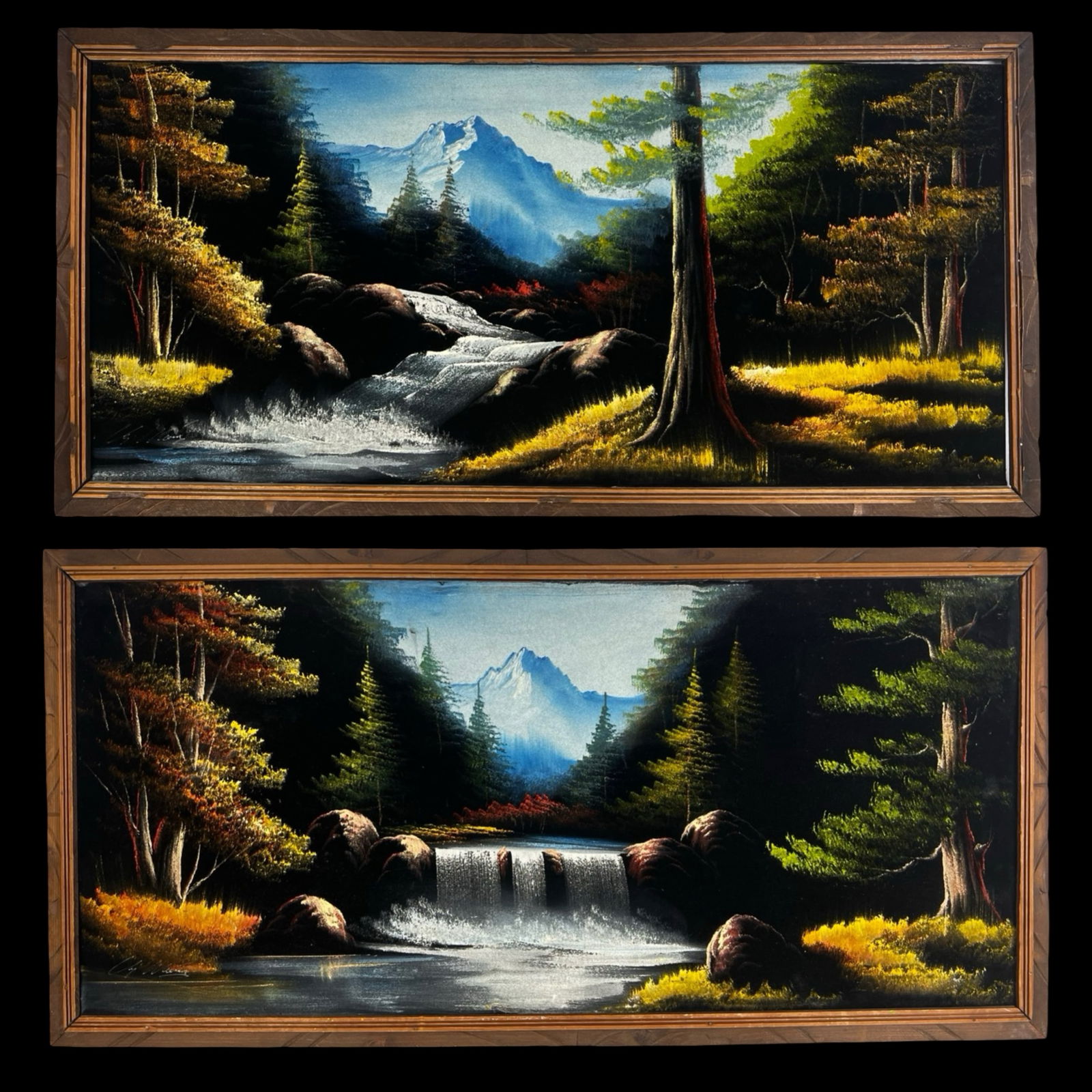 Pair of Vintage Black Velvet Landscape Paintings: Pair of vintage black velvet landscape paintings depicting dramatic mountain and waterfall scenes surrounded by forested landscapes. The compositions feature cascading water, rocky streams, and